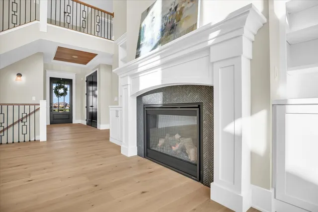 a large white kitchen with a sink and dishwasher with wooden floor