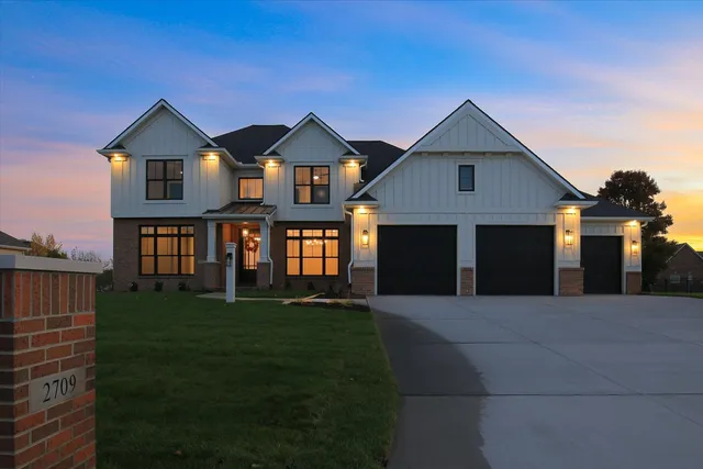 a front view of a house with a yard and garage