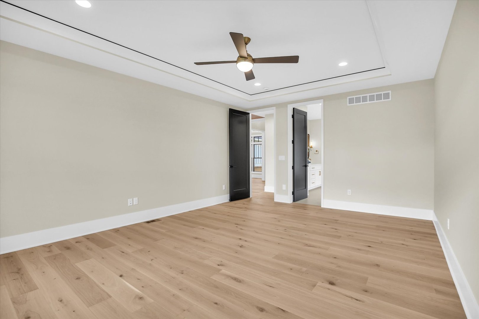 2709 East Castlerock Drive Urbana, IL 61802 - Photo 50 of 117 a view of an empty room with wooden floor and a ceiling fan