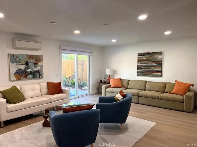 a living room with furniture a couch and a window