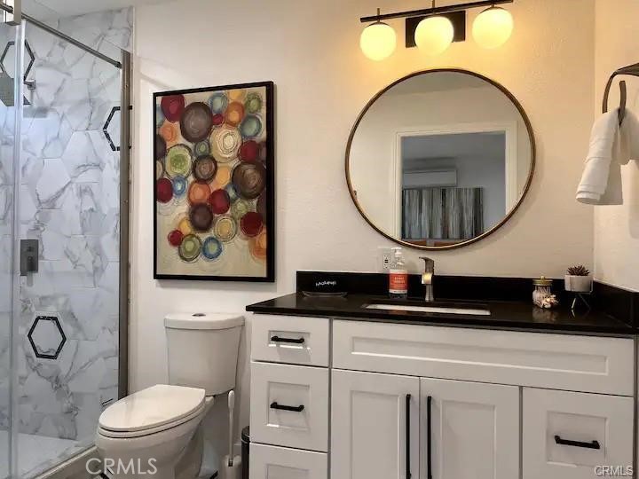 41830 6th Street Temecula, CA 92590 - Photo 7 of 8 a bathroom with a toilet a sink and a mirror