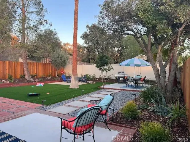 a view of a table and chairs in the garden