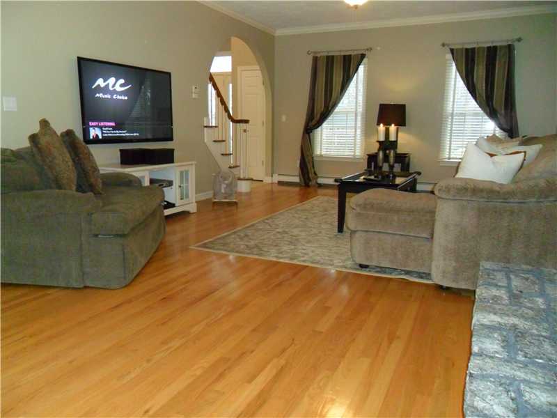 2 King Phillip Road Lincoln, RI 02865 - Photo 11 of 20 Living Room. LARGE LIVING ROOM FEATURES CROWN MOLDINGS, HARDWOOD FLOORING, STONE FIREPLACE, TWO SLIDERS WITH EXCEPTIONAL VIEW OF THIS BACKYARD !