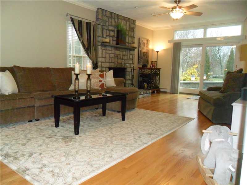 2 King Phillip Road Lincoln, RI 02865 - Photo 12 of 20 Living Room. LARGE LIVING ROOM, HARDWOODS, STONE FIREPLACE, SLIDERS, CROWN MOLDINGS WELCOME YOU IN THIS LOVELY COLONIAL HOME.