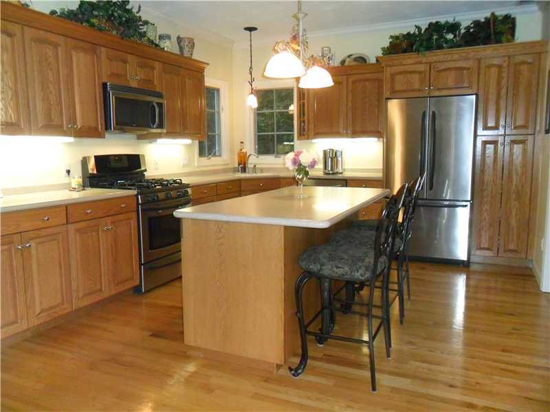 2 King Phillip Road Lincoln, RI 02865 - Photo 7 of 20 Dining Room. LARGE KITCHEN FEATURES HARDWOODS, LARGE KITCHEN CENTER ISLAND, STAINLESS APPLIANCES OPEN TO DINING AND LIVING.