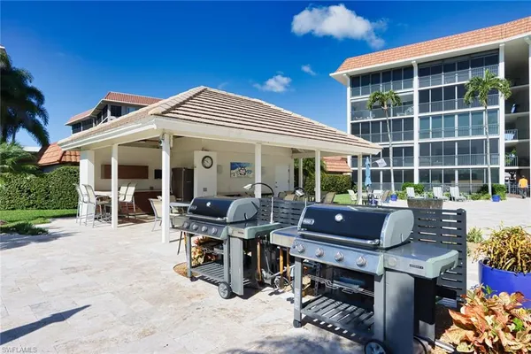 a view of a patio with a dining table and chairs