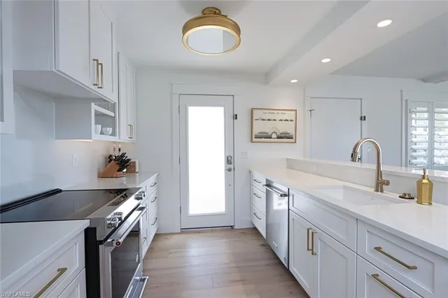 a kitchen with sink stove and cabinets