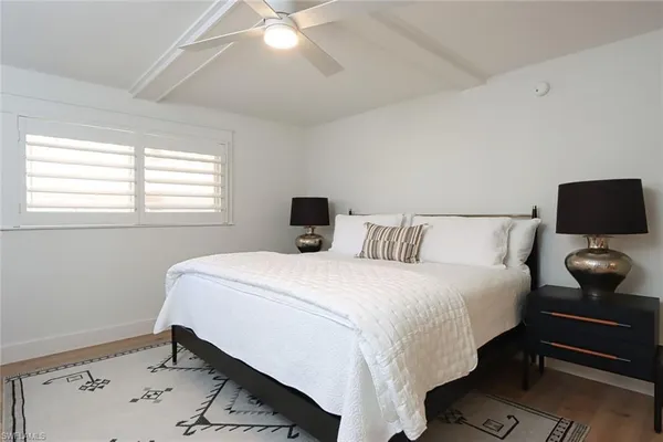 a bedroom with a bed and window