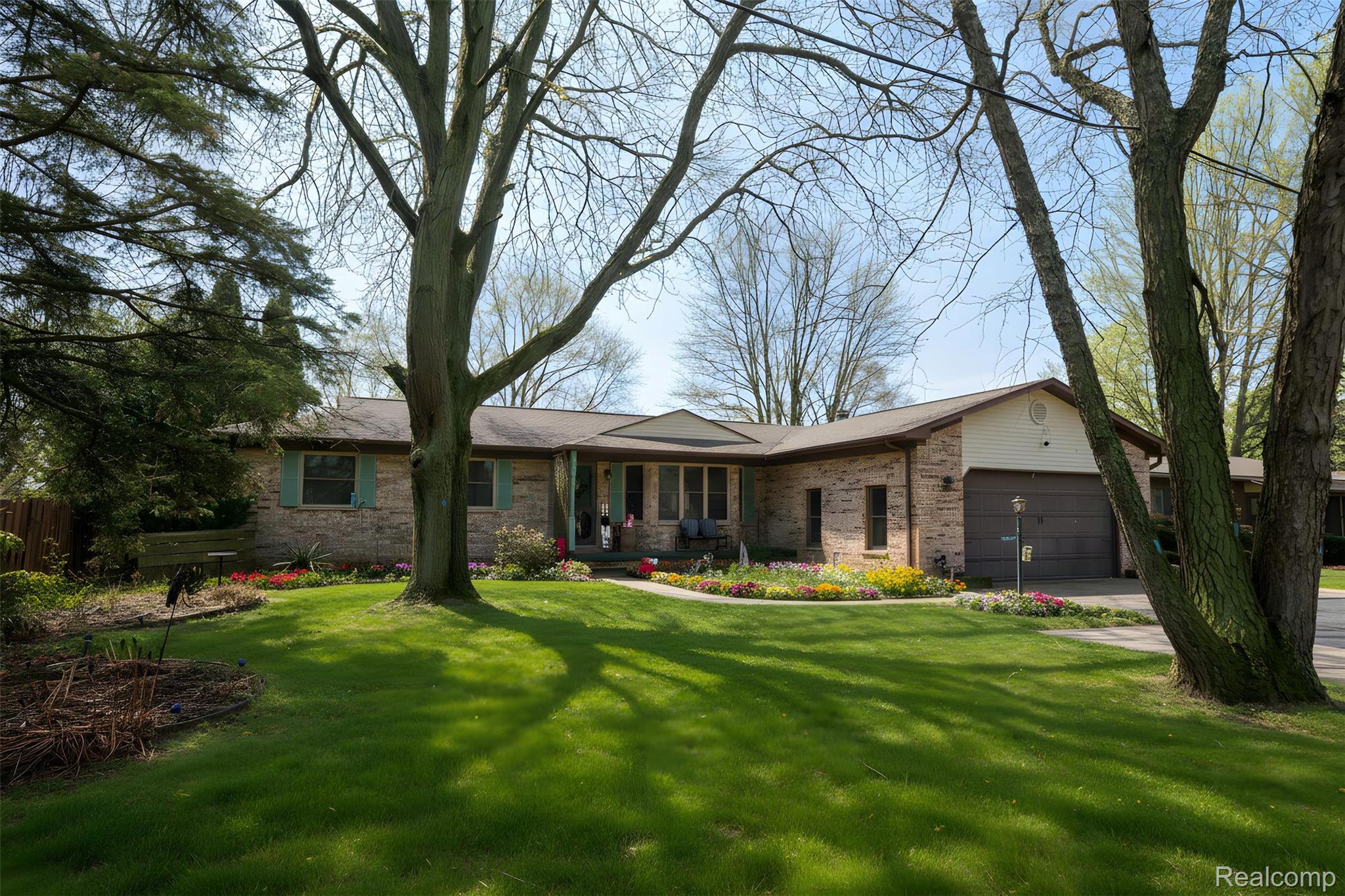 6076 East Carpenter Road Flint, MI 48506 - Photo 59 of 67 Ranch-style house with an attached garage, a front yard, brick siding, and driveway