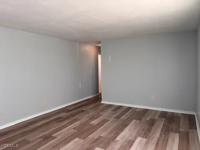 a view of room with wooden floor