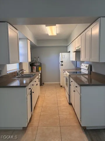 a kitchen with stainless steel appliances granite countertop a sink and cabinets