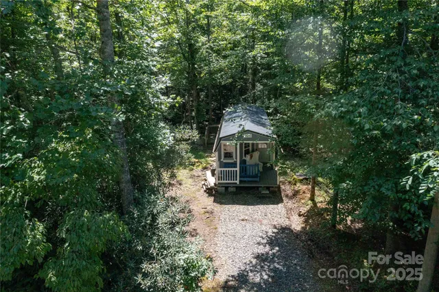 a view of house with outdoor space and trees