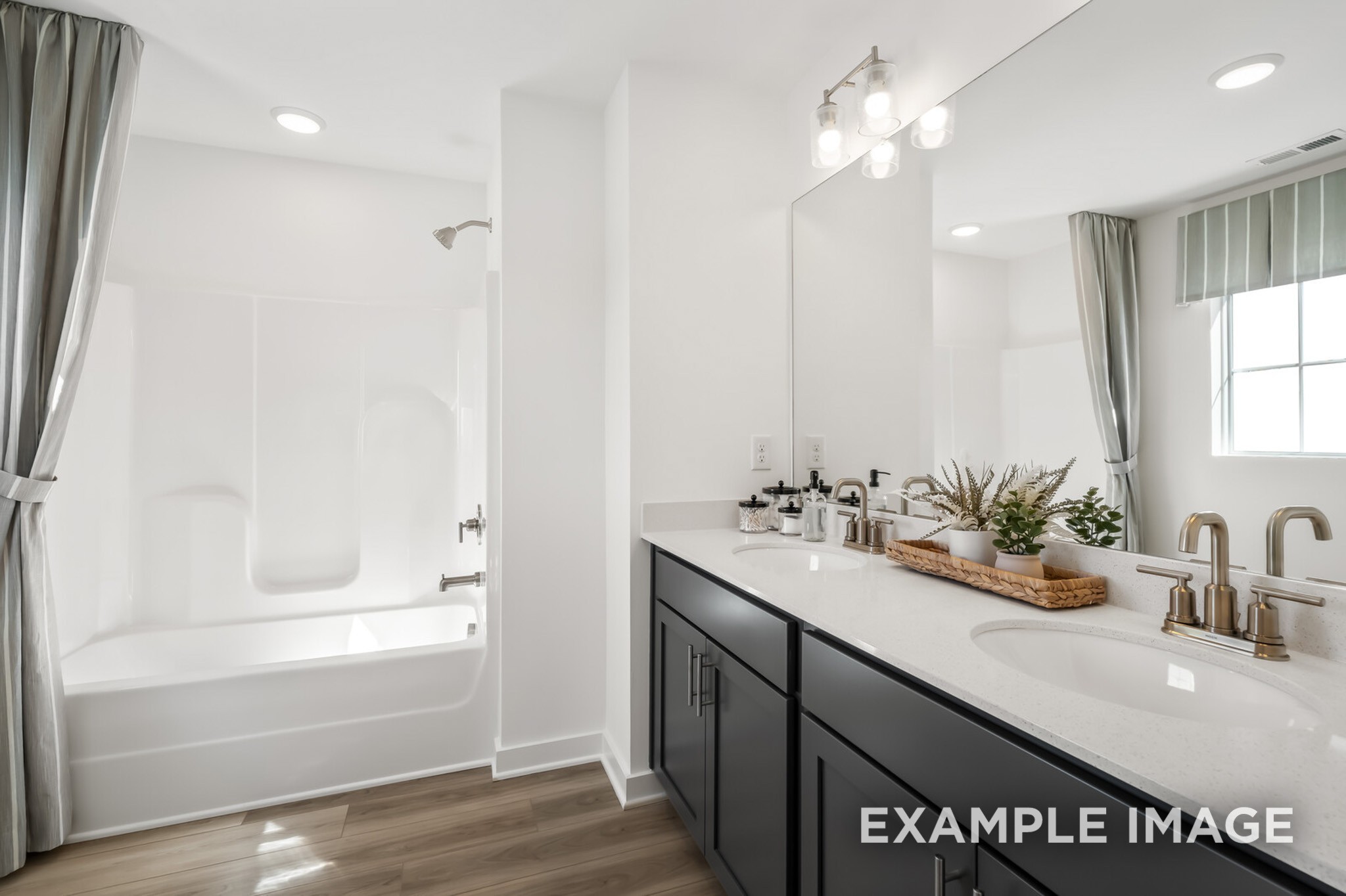 1733 Elliott Williams Way Gallatin, TN 37066 - Photo 18 of 23 a bathroom with a sink a large mirror and shower