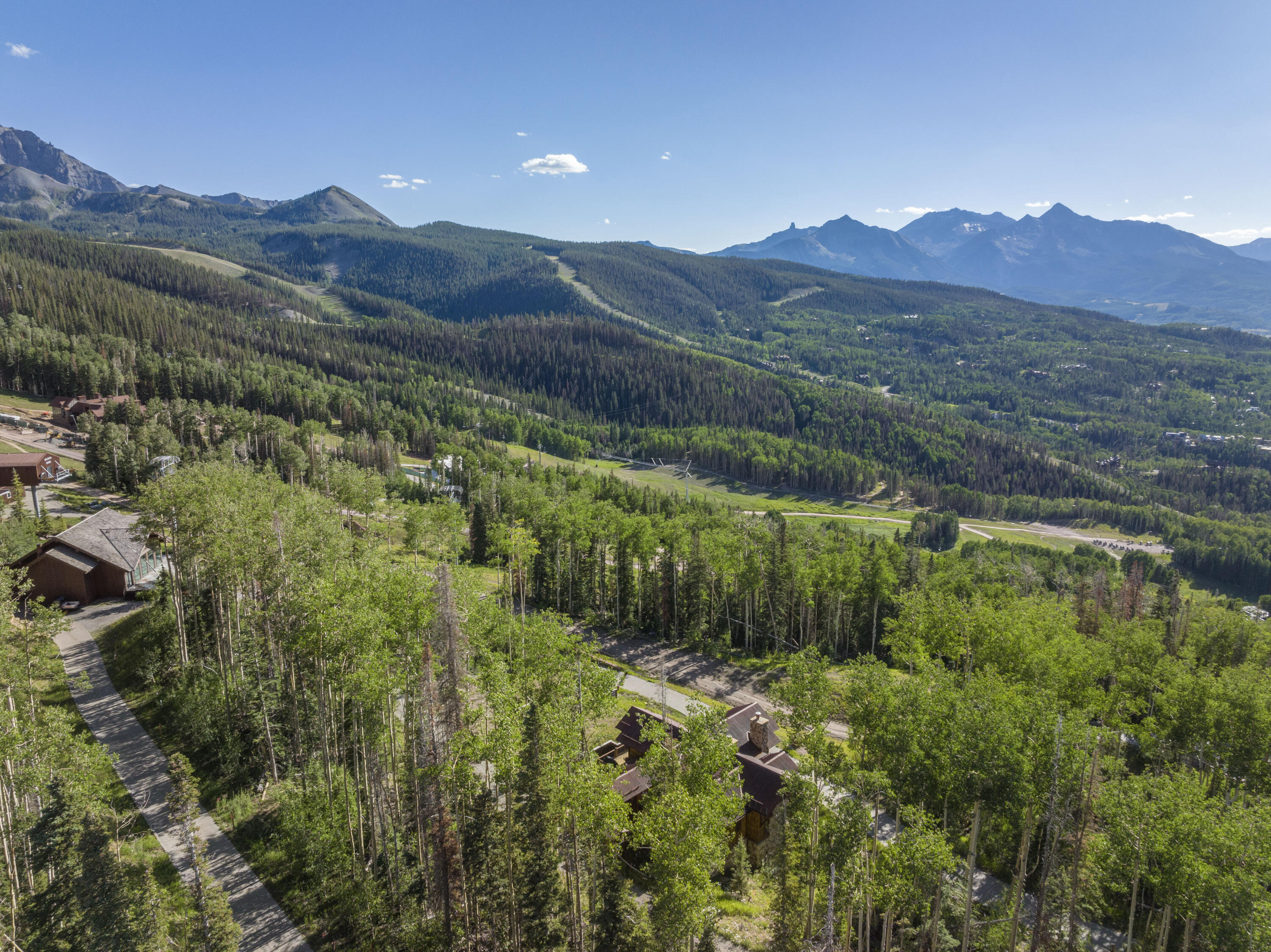 11 Coonskin Ridge Lane Mountain Village, CO 81435 - Photo 4 of 19 a view of a lush green hillside and a building