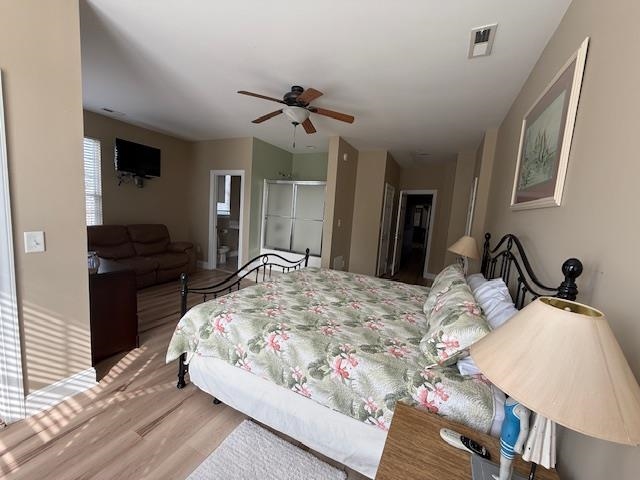 114 A 6th Avenue South Surfside Beach, SC 29575 - Photo 17 of 20 Bedroom with connected bathroom, wood finished floors, a closet, and ceiling fan