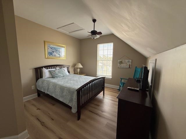 114 A 6th Avenue South Surfside Beach, SC 29575 - Photo 18 of 20 Bedroom featuring vaulted ceiling, ceiling fan, and light wood-style floors
