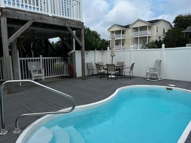 114 A 6th Avenue South Surfside Beach, SC 29575 - Photo 2 of 20 View of swimming pool featuring a wooden deck and outdoor dining space
