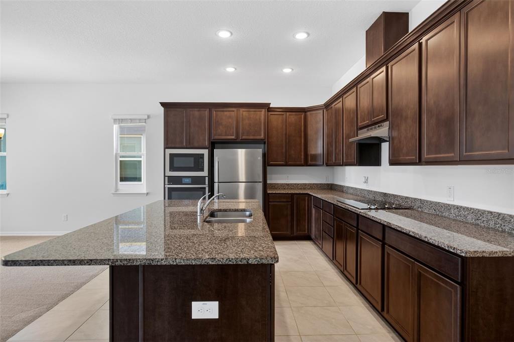 810 MIDDLETON Street DeBary, FL 32713 - Photo 9 of 52 a kitchen with stainless steel appliances granite countertop a sink a stove counter space and cabinets