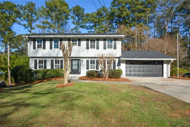 a front view of a house with a yard and porch