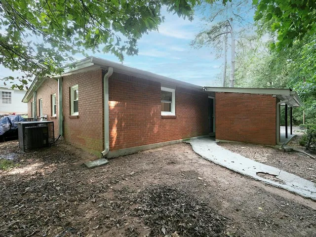 a backyard of a house with garage and car parked