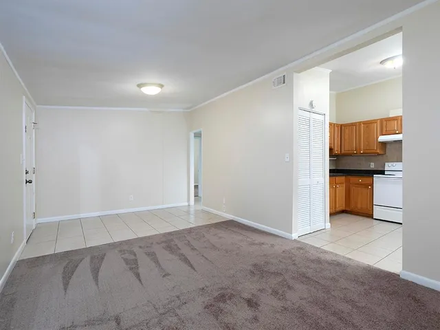 a view of kitchen and empty room