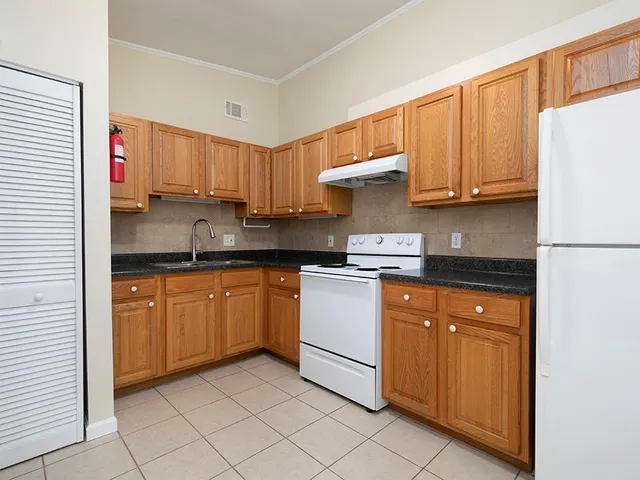 a kitchen with stainless steel appliances granite countertop a refrigerator sink and cabinets