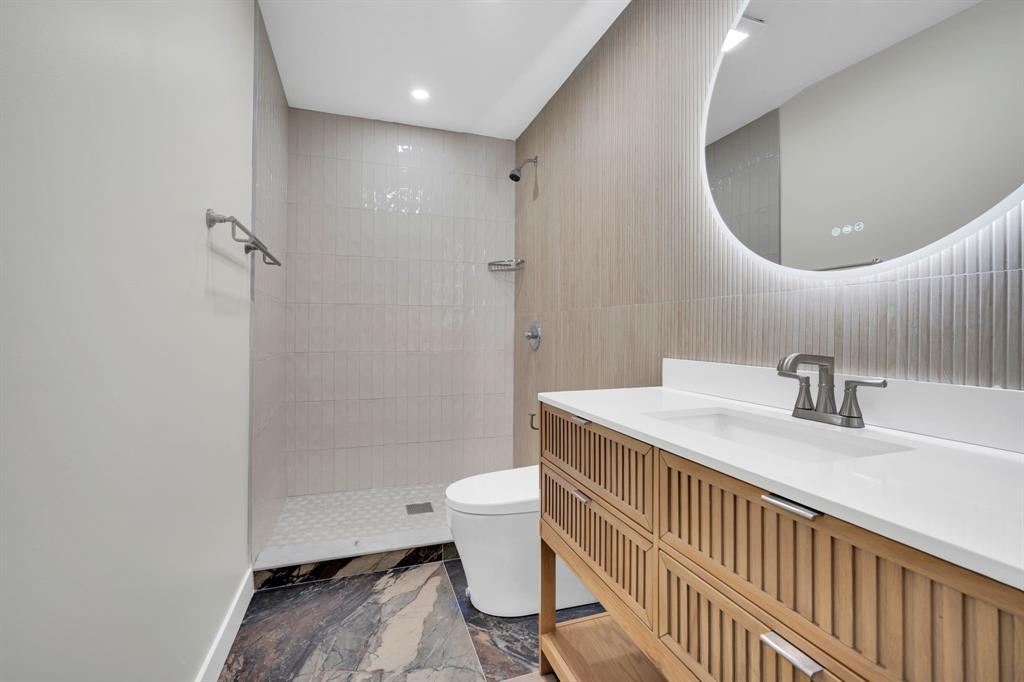 100 North Valley Street Red Oak, TX 75154 - Photo 11 of 31 a bathroom with a sink a toilet and a mirror