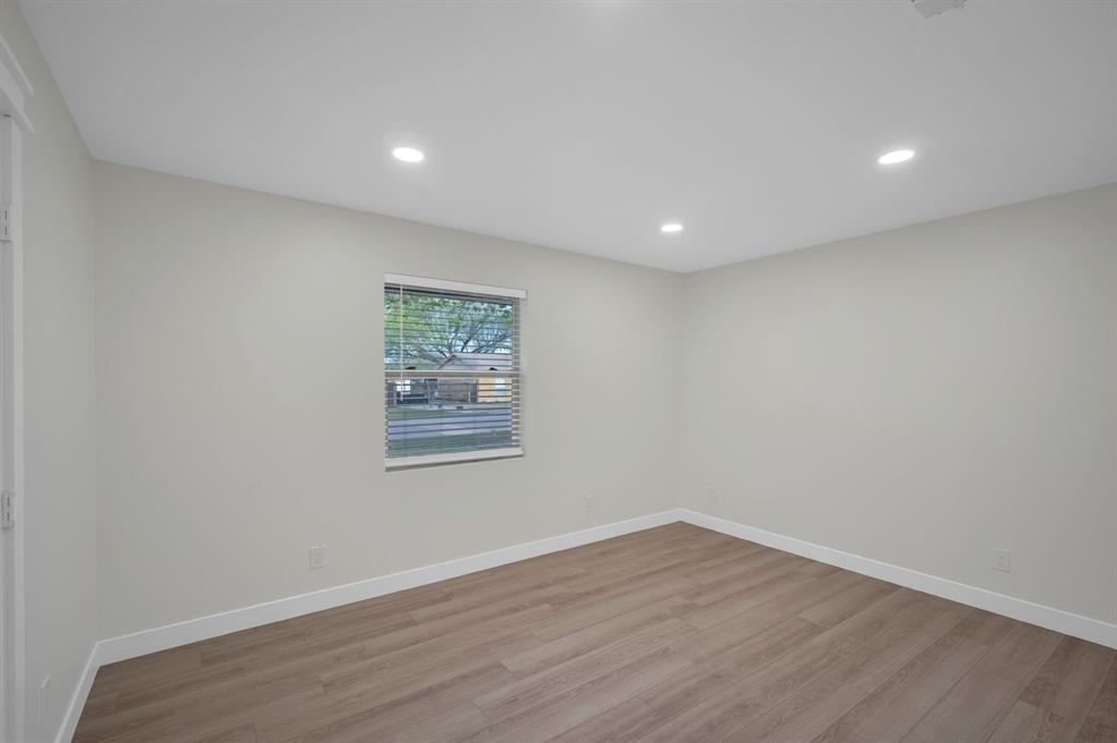 100 North Valley Street Red Oak, TX 75154 - Photo 12 of 31 a view of an empty room with wooden floor and a window