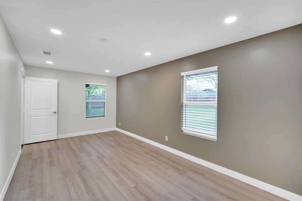 100 North Valley Street Red Oak, TX 75154 - Photo 16 of 31 an empty room with wooden floor and windows