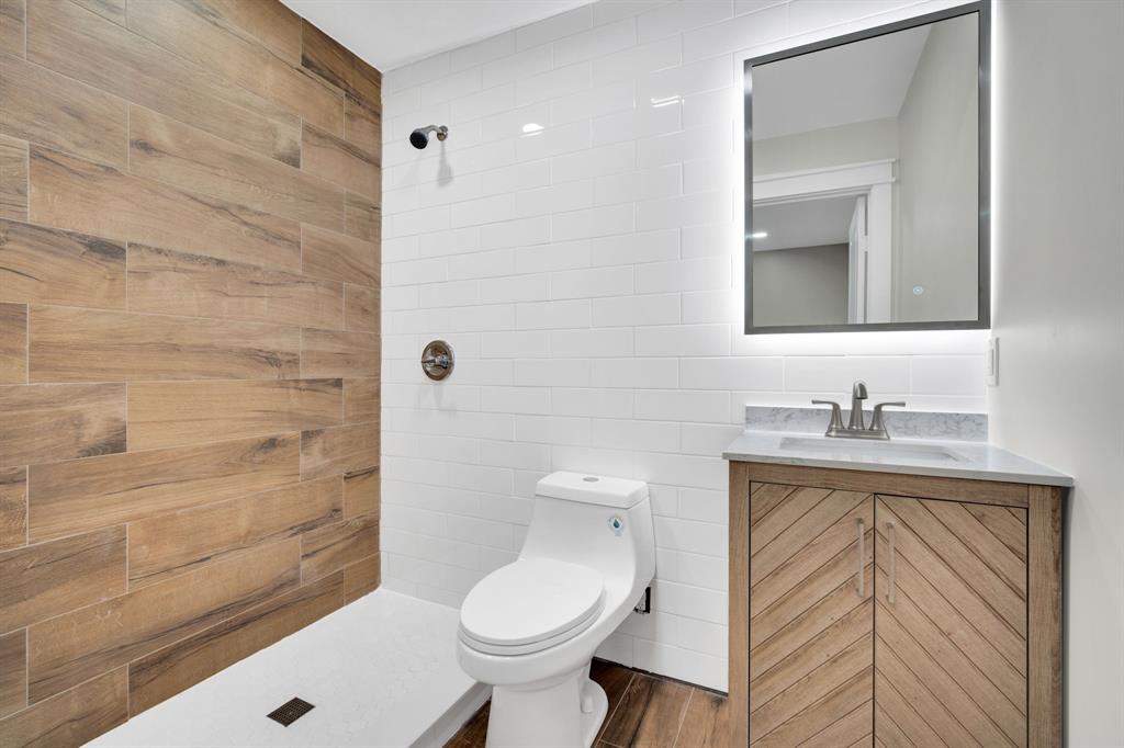 100 North Valley Street Red Oak, TX 75154 - Photo 17 of 31 a bathroom with a granite countertop sink toilet and shower
