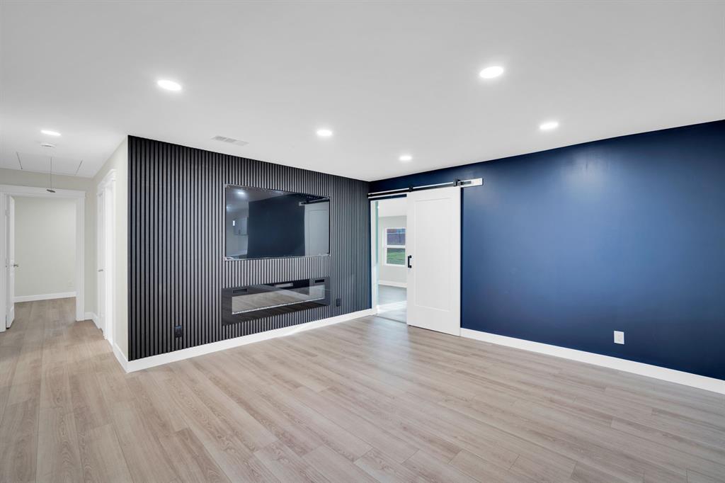 100 North Valley Street Red Oak, TX 75154 - Photo 2 of 31 a view of an empty room with wooden floor and a bathroom