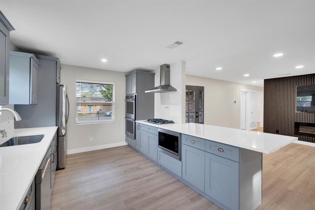 100 North Valley Street Red Oak, TX 75154 - Photo 5 of 31 a large kitchen with stainless steel appliances kitchen island a large counter top and a sink