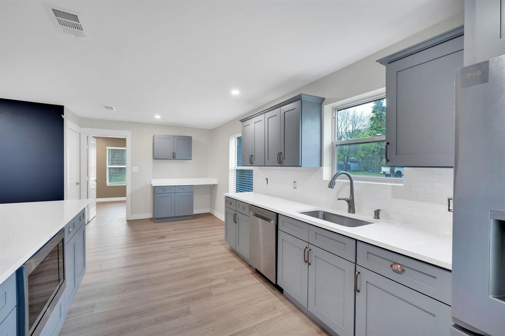 100 North Valley Street Red Oak, TX 75154 - Photo 6 of 31 a kitchen with a sink and cabinets