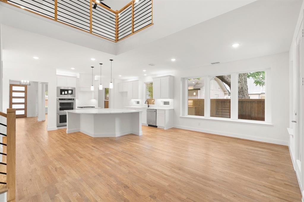 848 Northwood Road Fort Worth, TX 76107 - Photo 1 of 40 a view of kitchen with kitchen island a sink wooden floor and a refrigerator