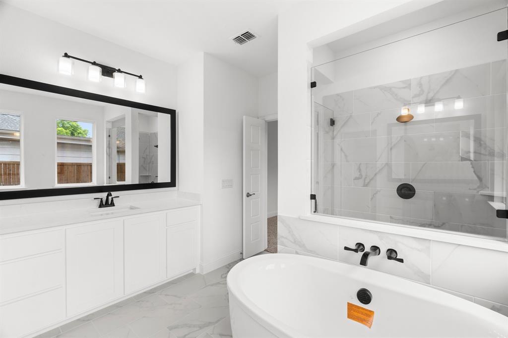 848 Northwood Road Fort Worth, TX 76107 - Photo 11 of 40 a bathroom with a tub sink and mirror