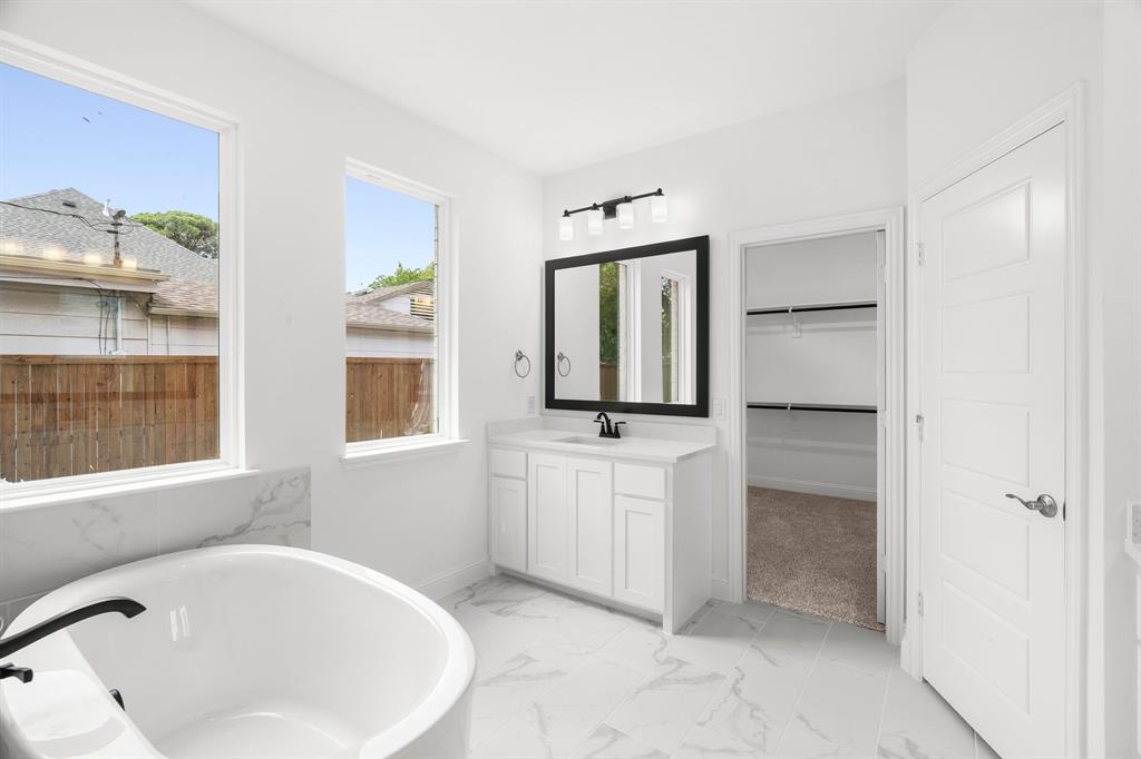848 Northwood Road Fort Worth, TX 76107 - Photo 12 of 40 a bathroom with a bathtub and a window