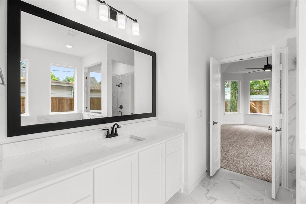 848 Northwood Road Fort Worth, TX 76107 - Photo 13 of 40 a bathroom with a sink and a mirror