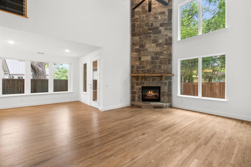 848 Northwood Road Fort Worth, TX 76107 - Photo 15 of 40 an empty room with wooden floor fireplace and windows