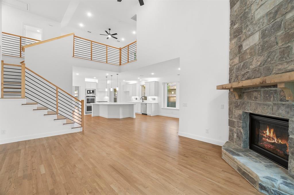 848 Northwood Road Fort Worth, TX 76107 - Photo 16 of 40 a view of an empty room with wooden floor fireplace and a window