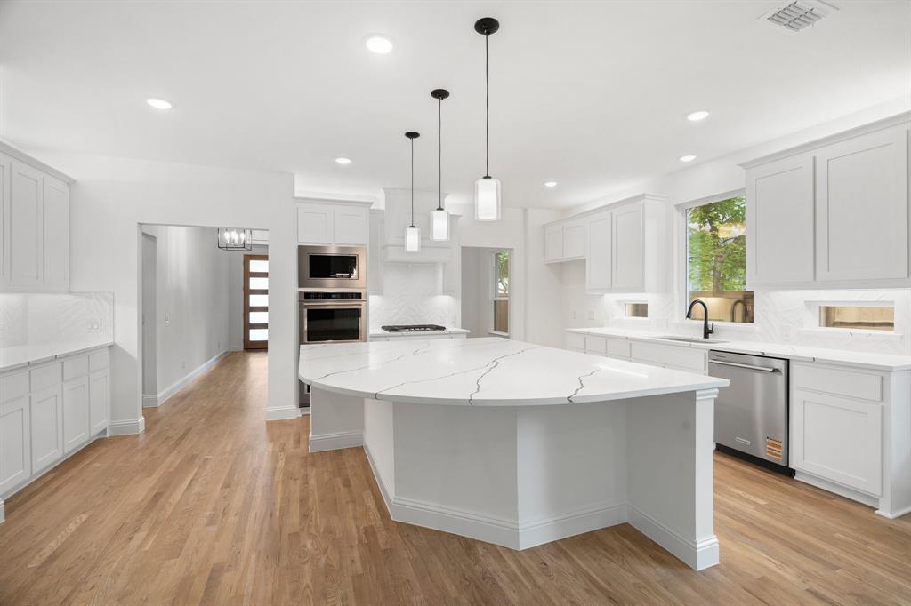 848 Northwood Road Fort Worth, TX 76107 - Photo 2 of 40 a large kitchen with stainless steel appliances a large center island attached withe living room