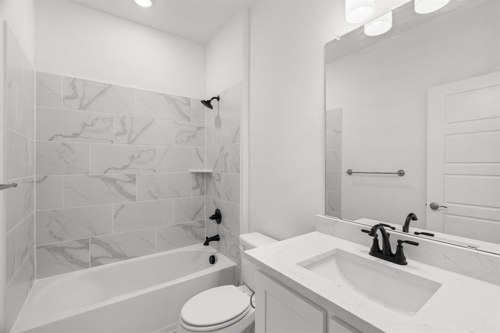 848 Northwood Road Fort Worth, TX 76107 - Photo 24 of 40 a bathroom with a sink a toilet and bathtub