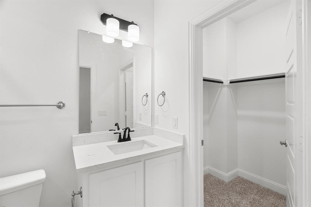 848 Northwood Road Fort Worth, TX 76107 - Photo 28 of 40 a bathroom with a sink a light fixture and a mirror