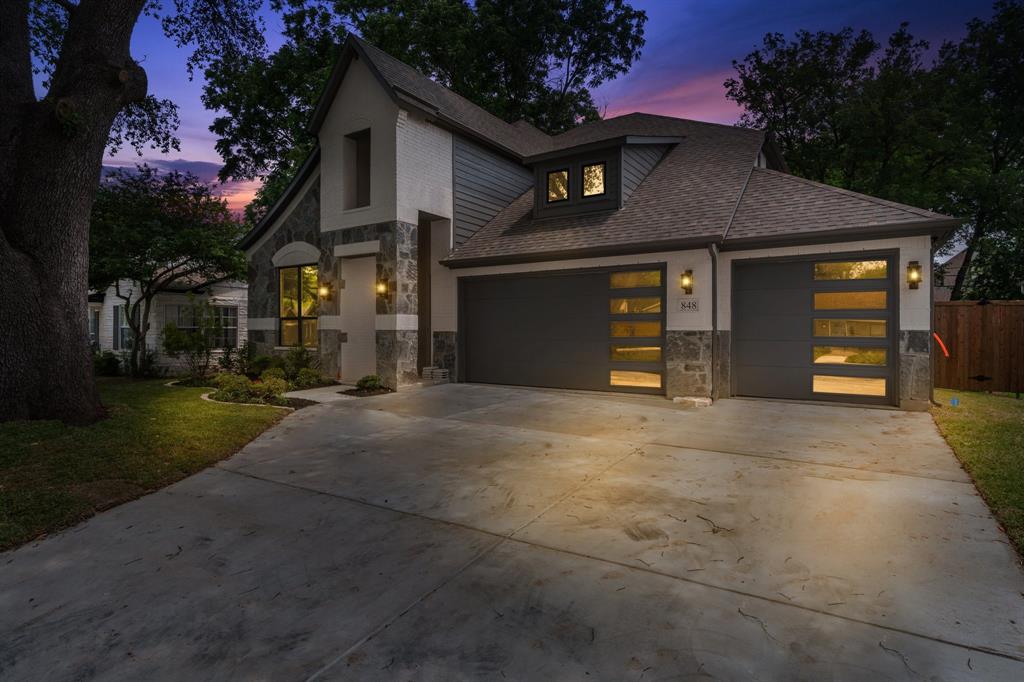 848 Northwood Road Fort Worth, TX 76107 - Photo 35 of 40 a front view of a house with a yard and garage
