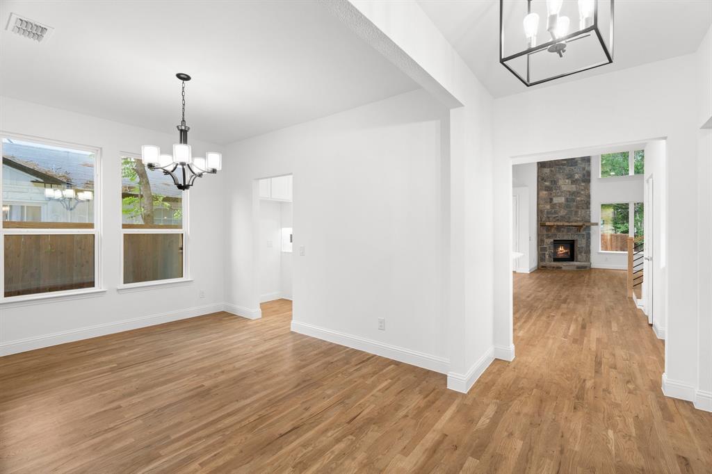 848 Northwood Road Fort Worth, TX 76107 - Photo 6 of 40 a view of an empty room with wooden floor and a chandelier