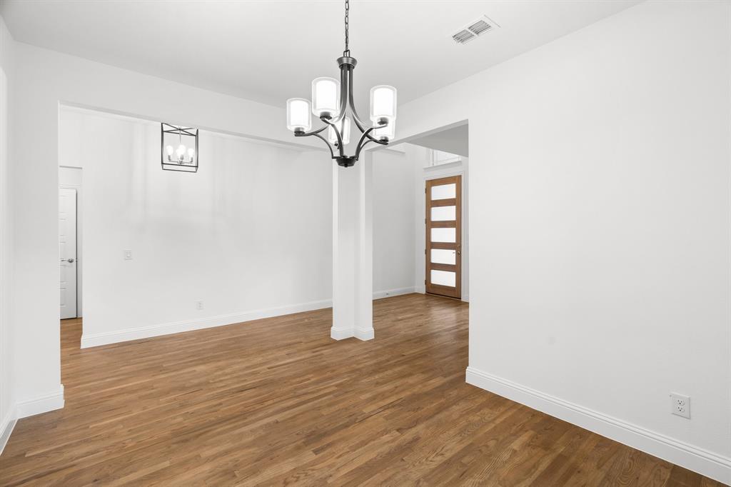 848 Northwood Road Fort Worth, TX 76107 - Photo 7 of 40 a view of an empty room with wooden floor and a ceiling fan