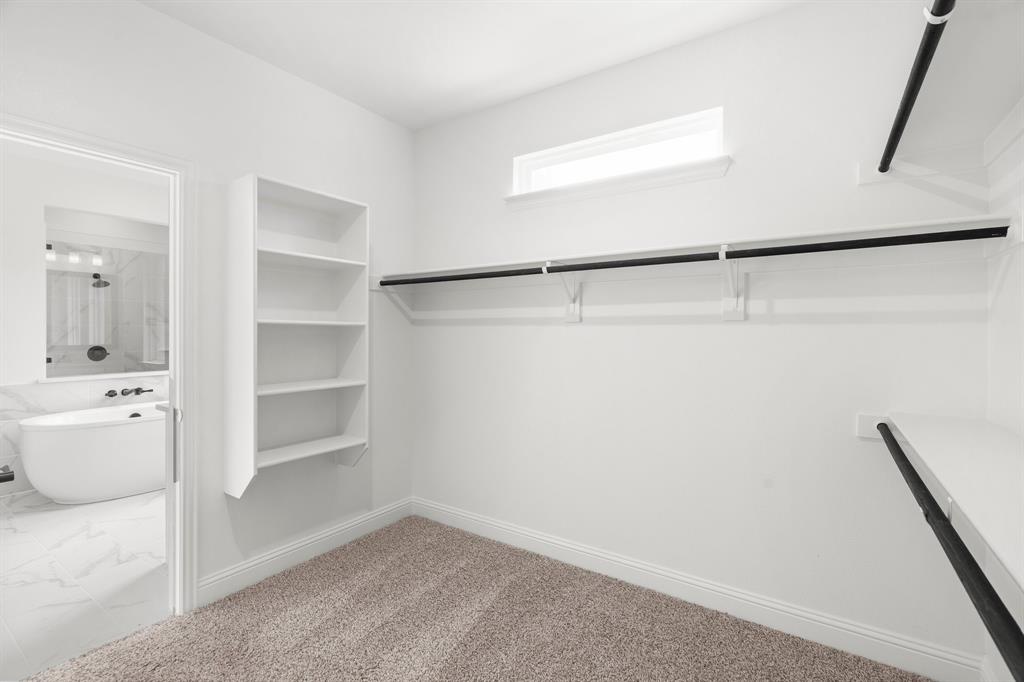 848 Northwood Road Fort Worth, TX 76107 - Photo 9 of 40 a view of walk in closet with empty racks