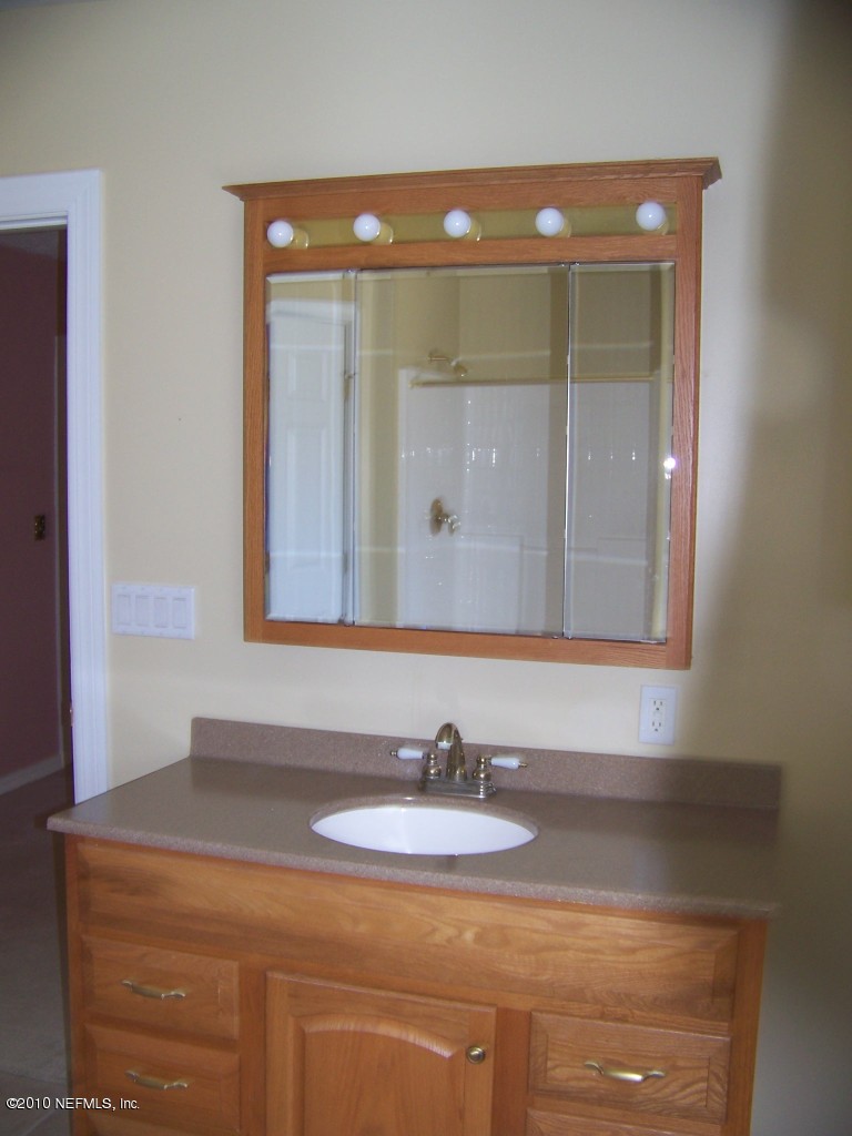 9761 Kline Road Jacksonville, FL 32246 - Photo 28 of 71 a bathroom with a sink and a mirror