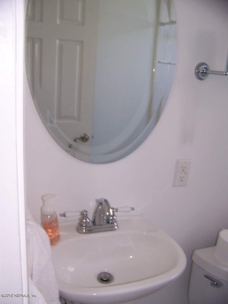 9761 Kline Road Jacksonville, FL 32246 - Photo 35 of 71 a bathroom with a sink a toilet and mirror