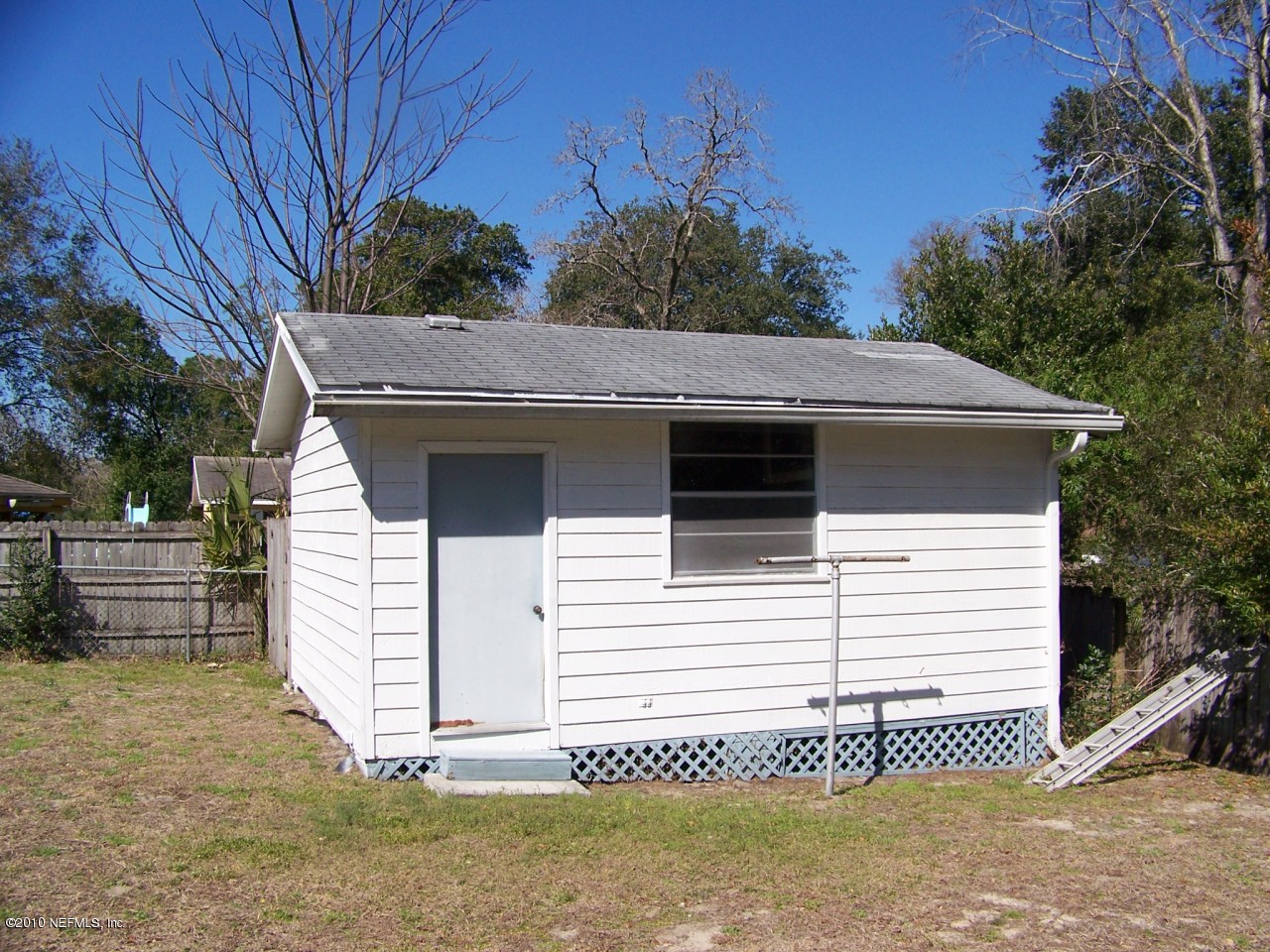 9761 Kline Road Jacksonville, FL 32246 - Photo 50 of 71 a view of a white house with a small yard and a large window