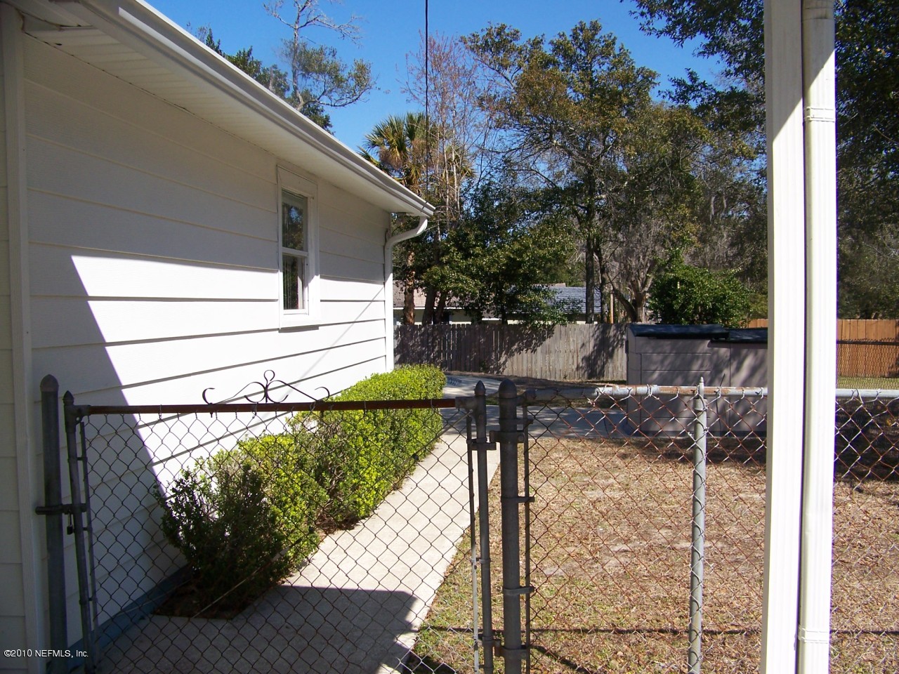 9761 Kline Road Jacksonville, FL 32246 - Photo 66 of 71 a view of a small yard and a wooden deck
